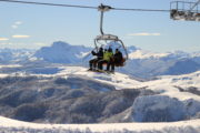 Winter Holiday Guests on a Ski Lift up a Mountain in Kolasin