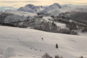 Skiing as the sun sets over the snowy mountains of Kolasin, Montenegro
